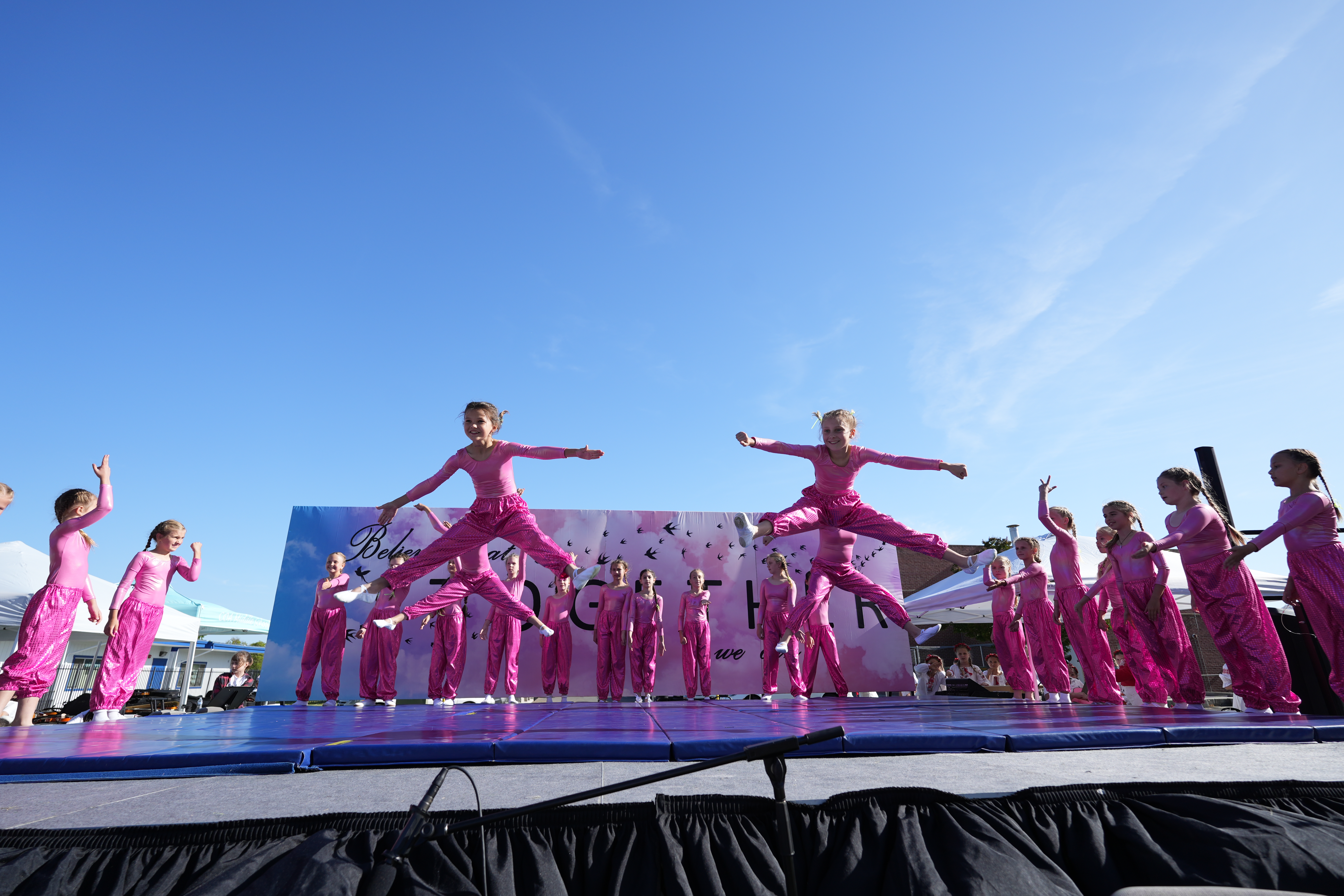 Girl dance team performing aerial jump