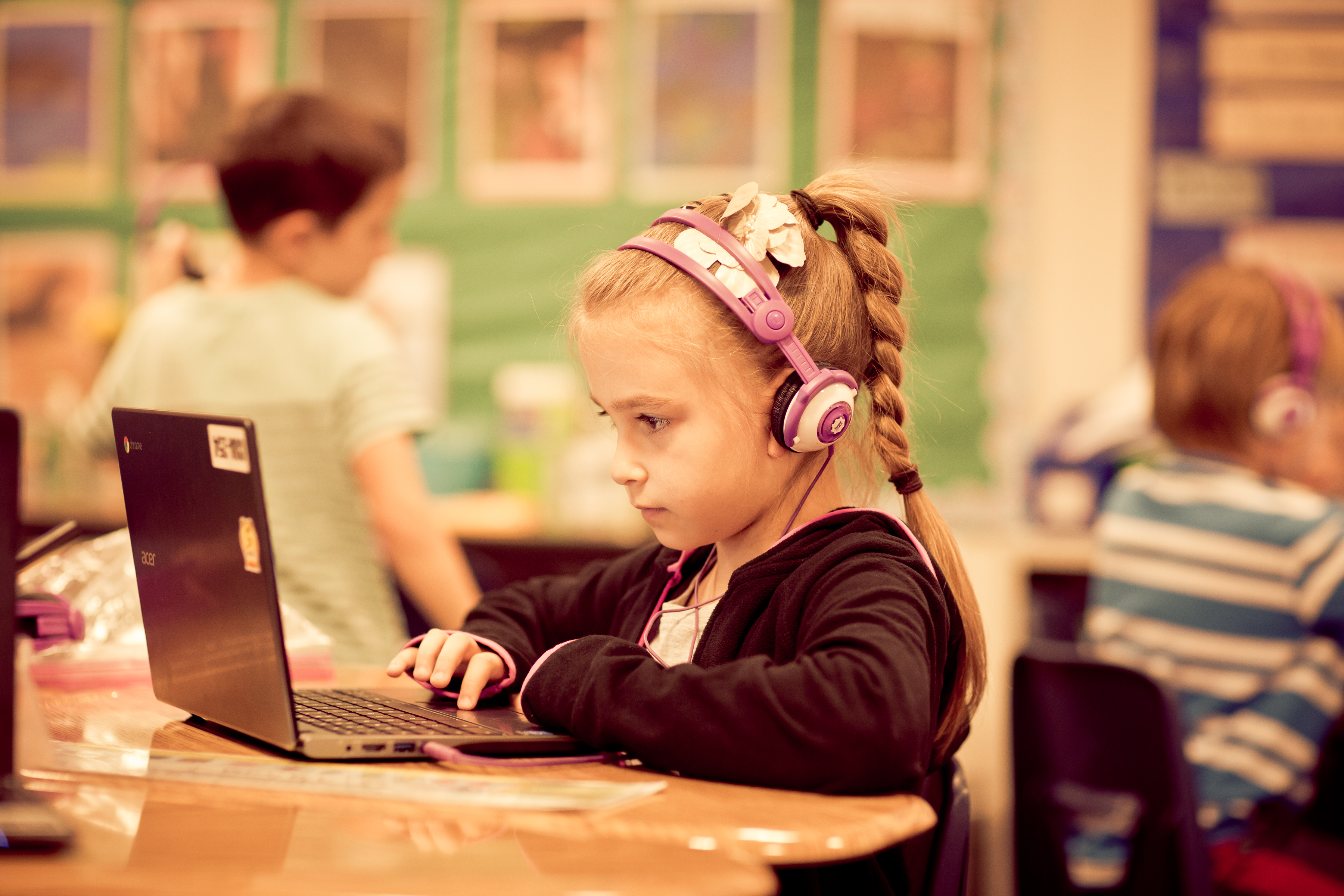 student on laptop wearing headphones 