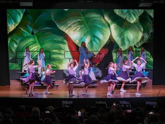 students performing dance on stage