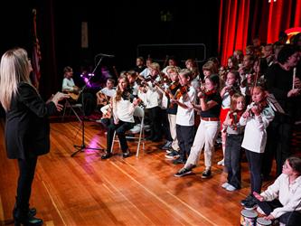 student orchestra performing on stage