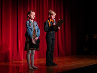 two students opening show on stage 