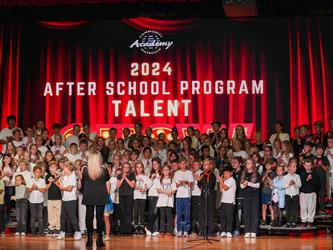 students lined up to sing on stage