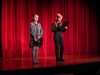 student hosts addressing the crowd