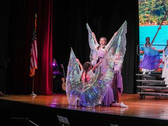 students performing dance on stage