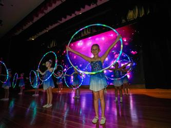 students performing on stage 