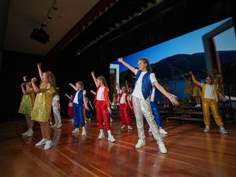 students dancing on stage for talent show