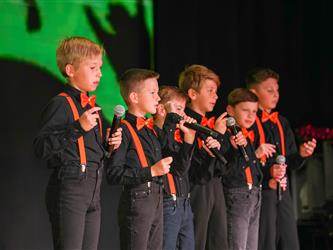 students lined up to sing on stage