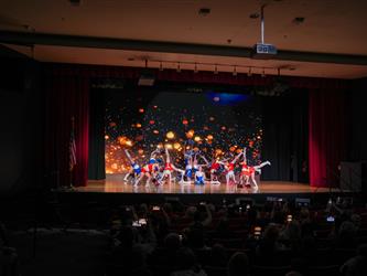 students performing cheerleading stunt 