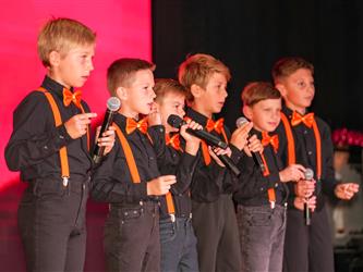 students lined up to sing on stage