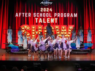 students in front of talent show sign