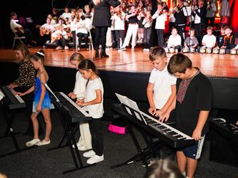 student orchestra performing on stage