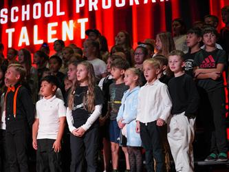 students lined up to sing on stage