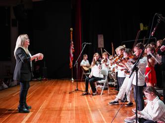 student orchestra performing on stage