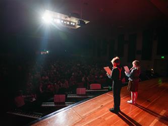 student hosts addressing the crowd