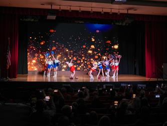 students performing cheerleading stunt 