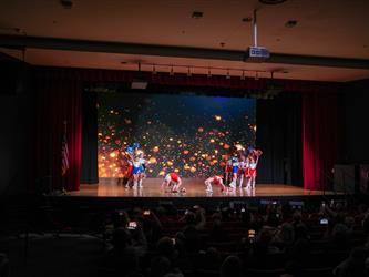 students performing cheerleading stunt 