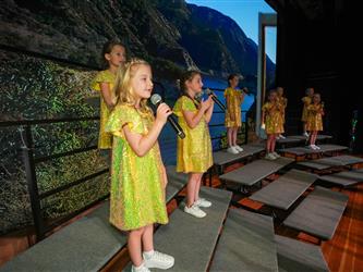 students singing on stage for talent show