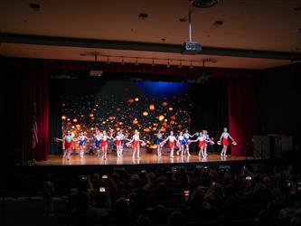 students performing cheerleading stunt 