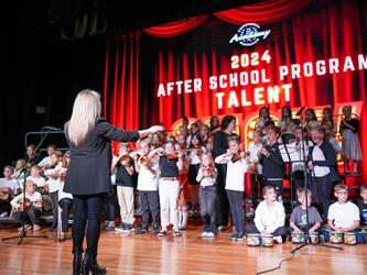 student orchestra performing on stage