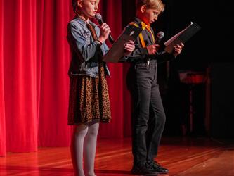 student hosts addressing the crowd