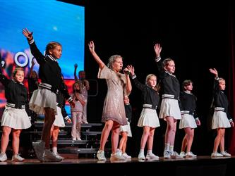 students lined up to sing on stage